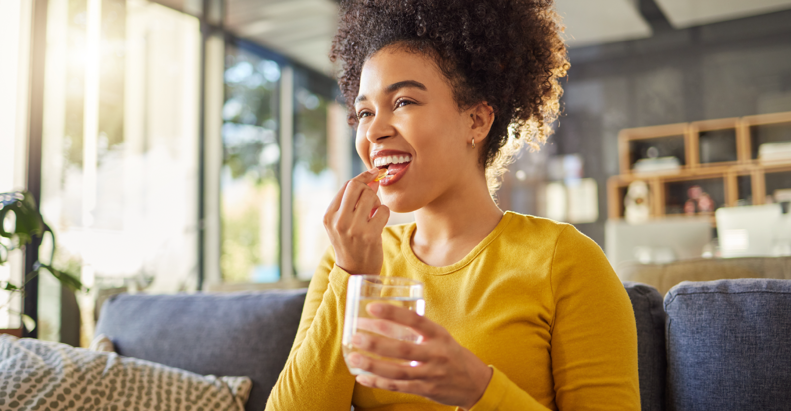 woman taking vitamins in the morning 
